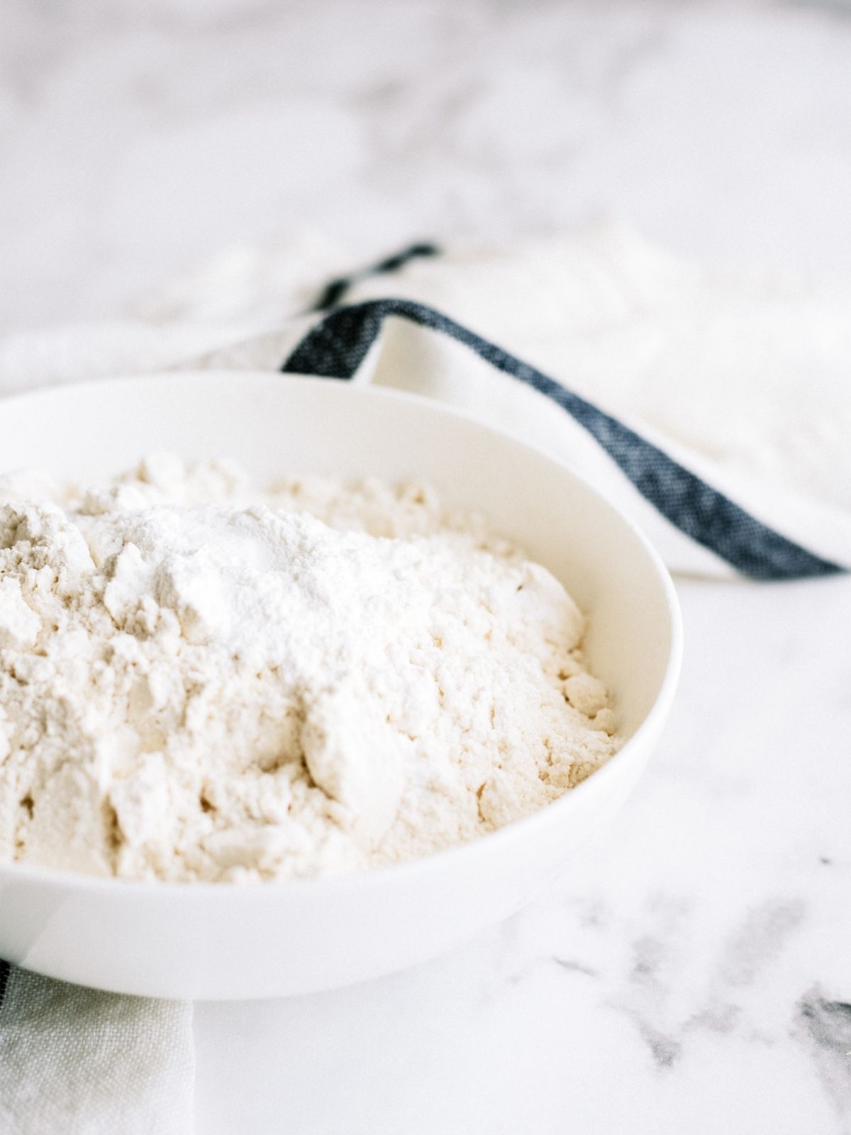 flour and baking powder in white bowl for Snickerdoodle Blondies Recipe