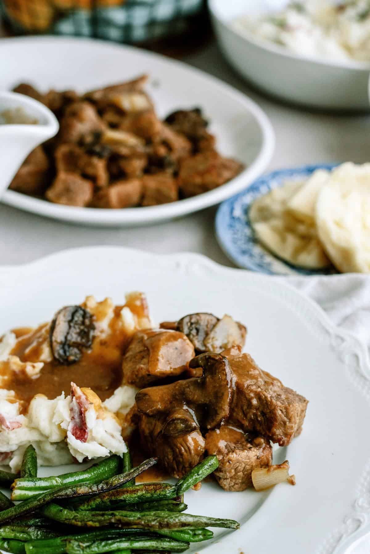 Frozen beef tips coated in flour and seasoning for Instant Pot recipe.