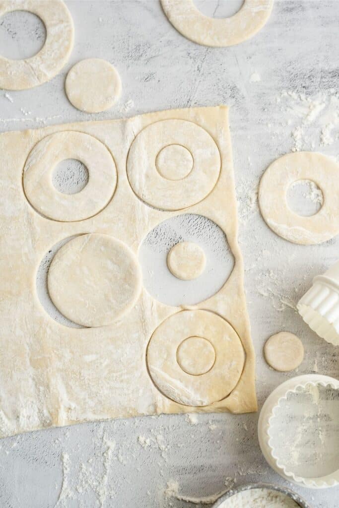 Cutting circles out of puff pastry dough.