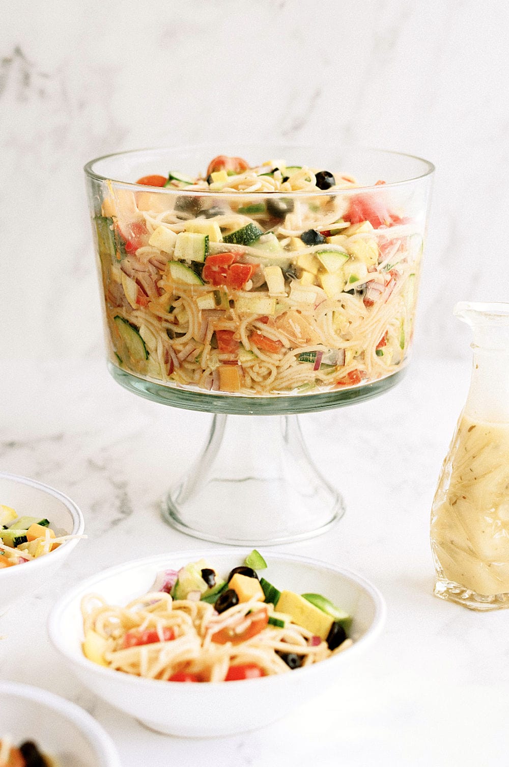 spaghetti pasta salad ready to serve in glass serving bowl