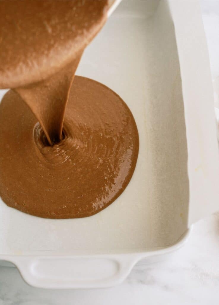Cake batter poured into a white baking dish.