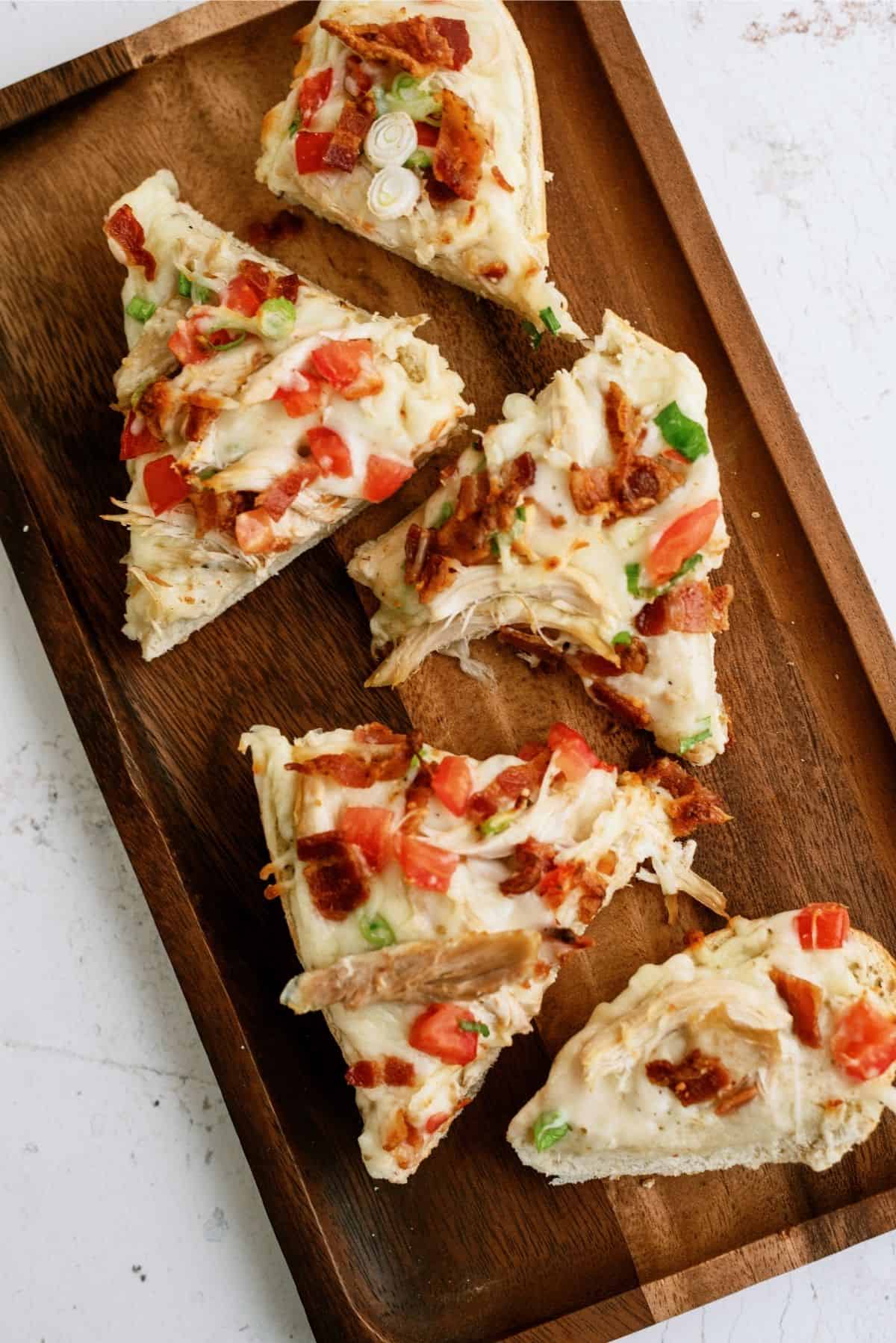 Chicken Bacon Alfredo French Bread Pizza on Cutting Board