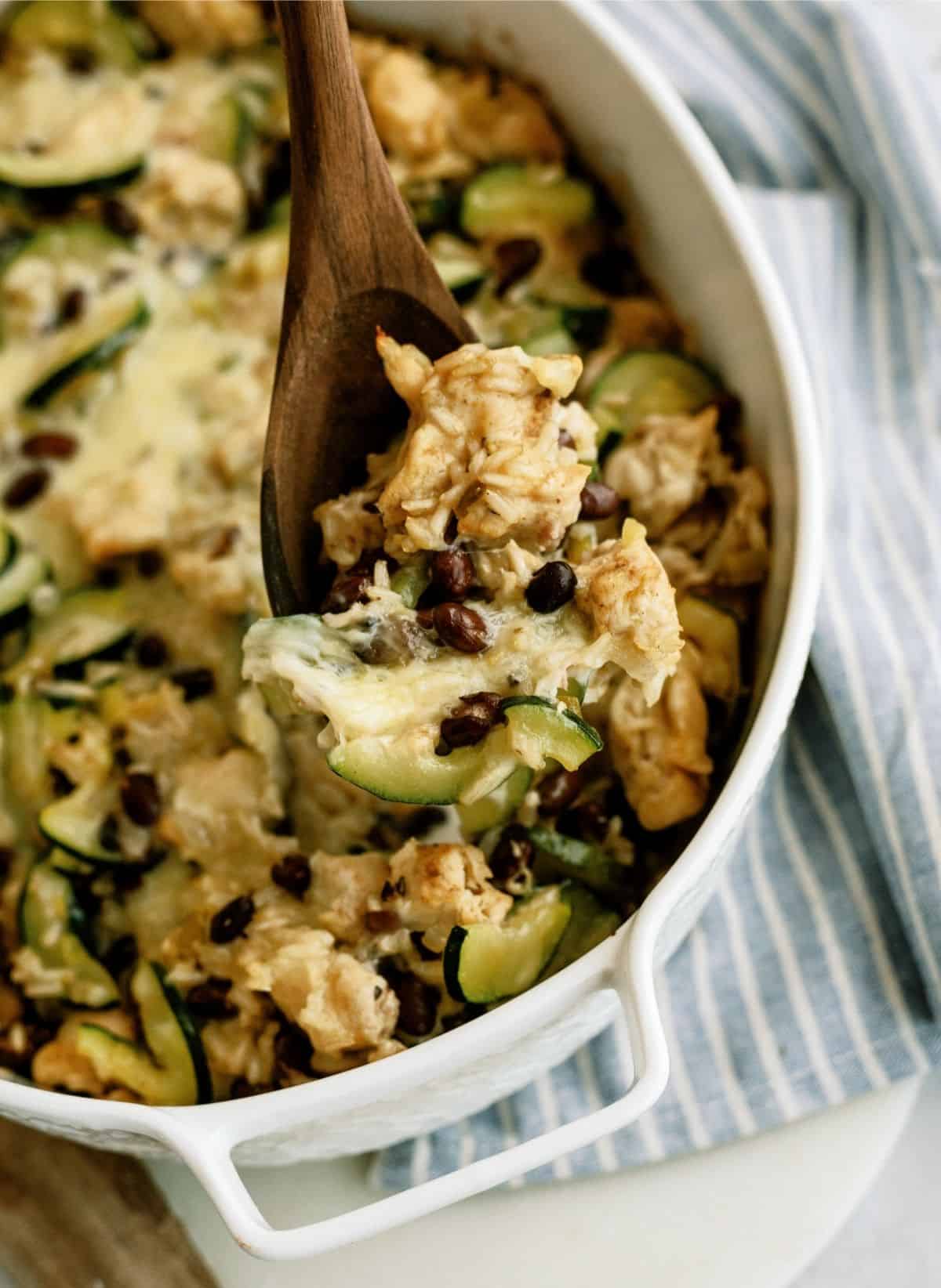 Chicken and Black Bean Casserole in a white casserole dish with a wooden spoon