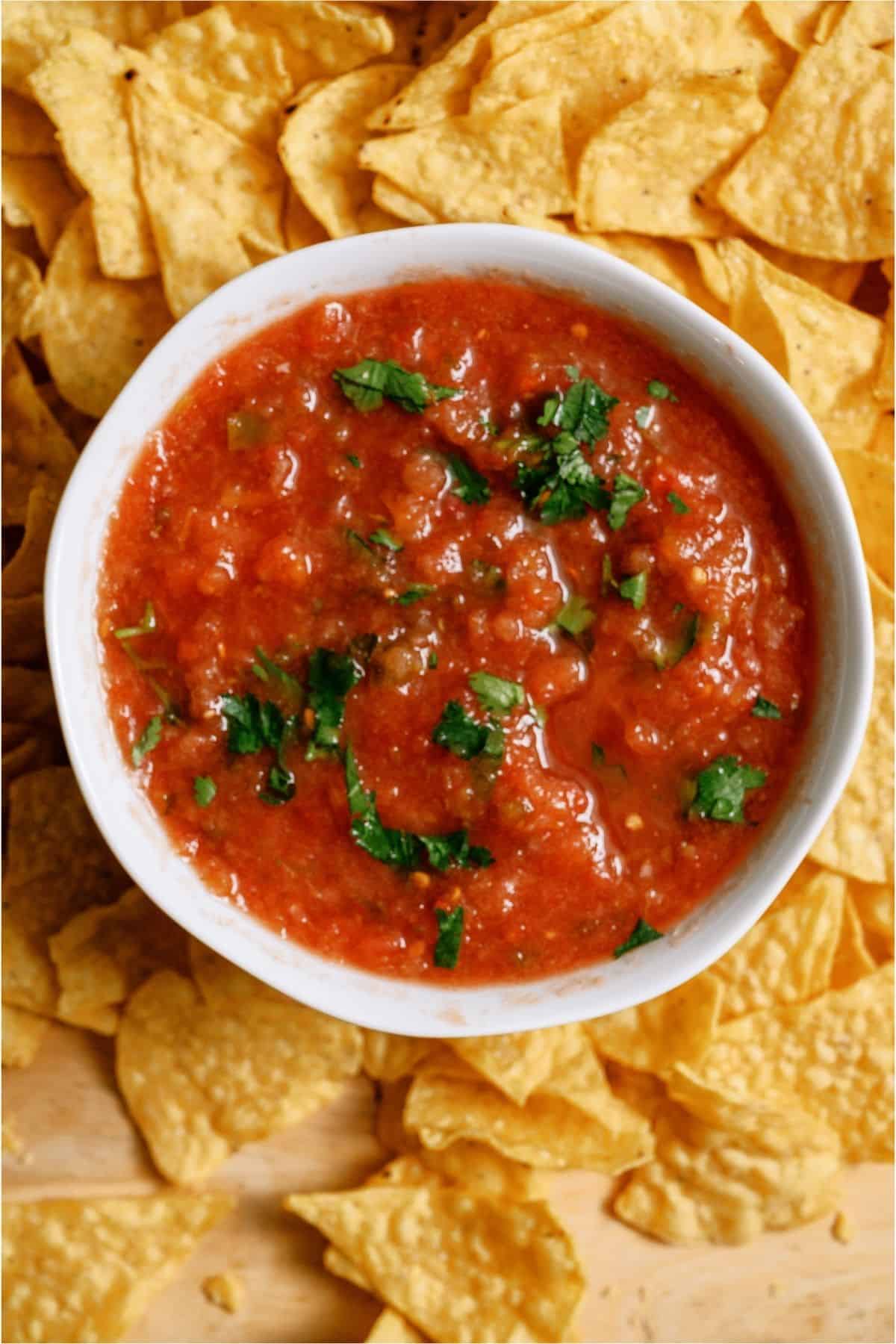 Top view of a bowl of Chili's Copycat Salsa surrounded by tortilla chips.