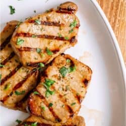 Top view of Marinated Grilled Pork Chops on a white plate.
