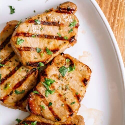 Top view of Marinated Grilled Pork Chops on a white plate.
