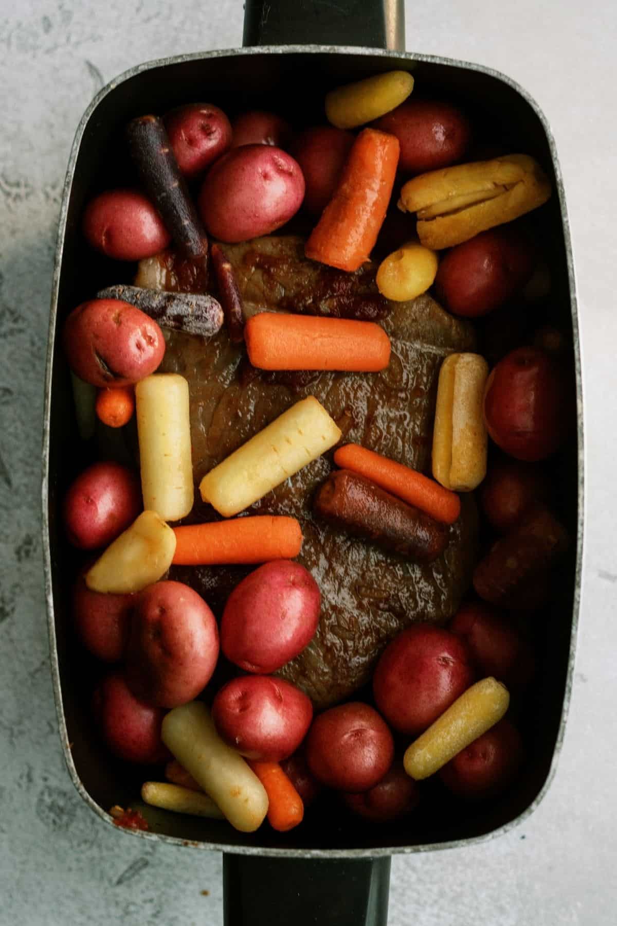 mixing all sauce ingredients for Melt in Your Mouth Slow Cooker Pot Roast Recipe in a slow cooker