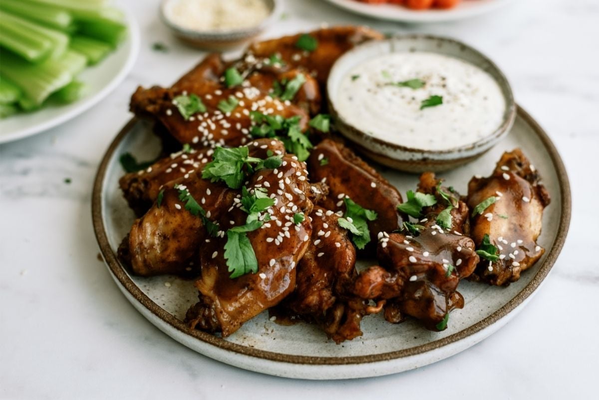 Slow Cooker Sticky Chicken Wings on a plate with dip