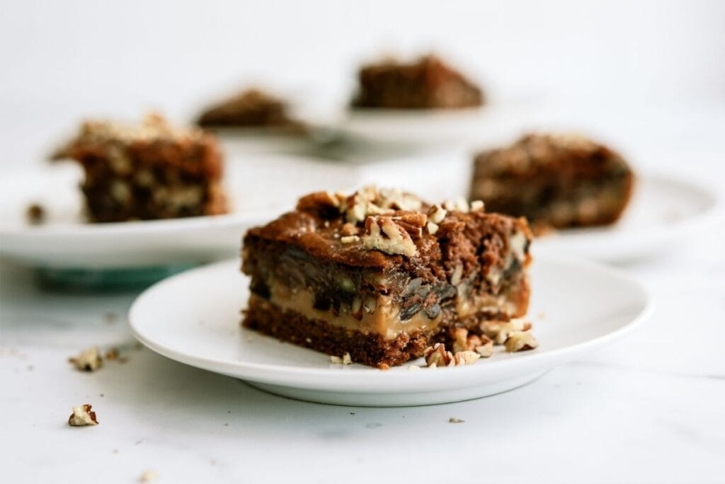 Slices of Snickers Cake on white plate.