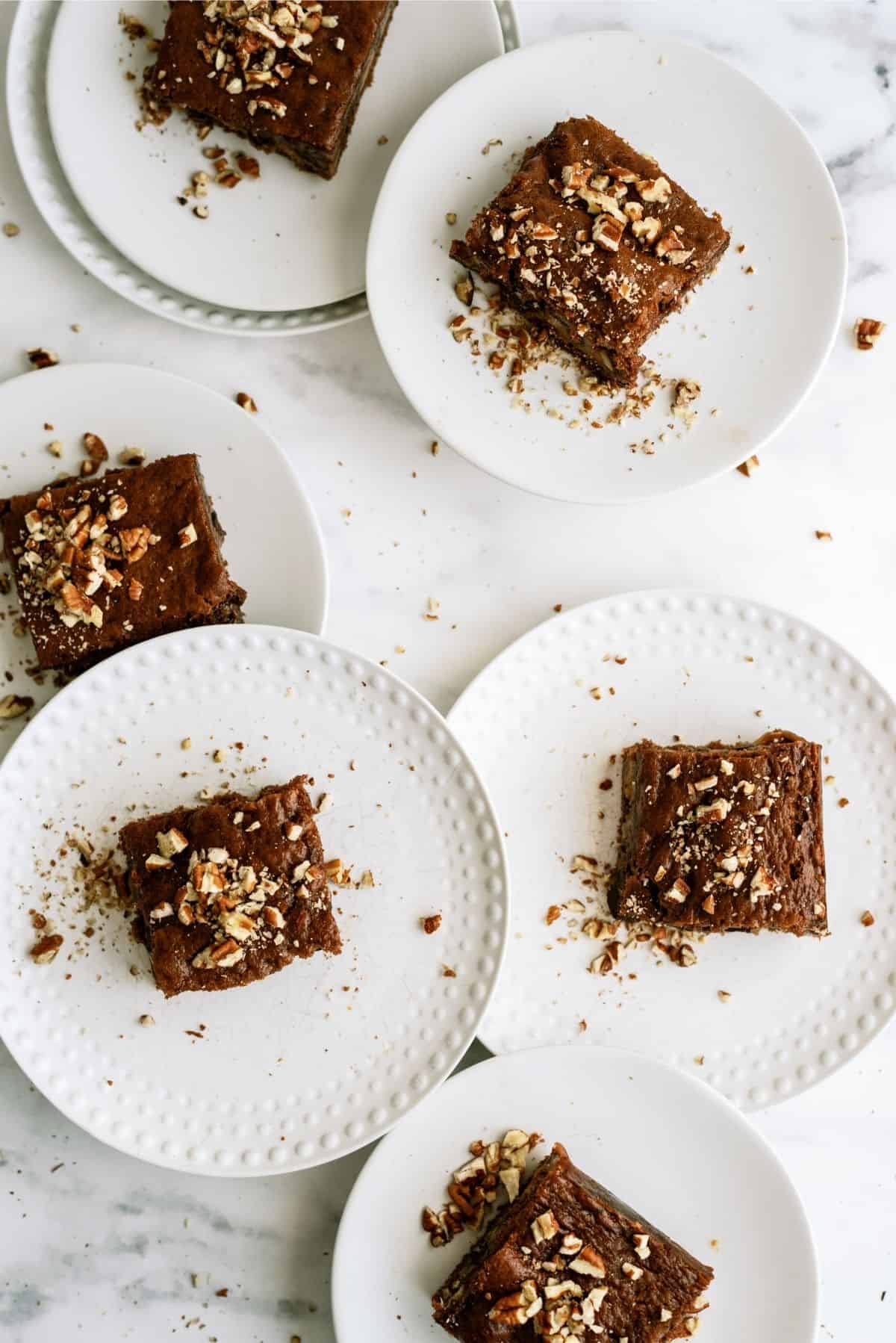 Snickers Cake sliced and served on white plates