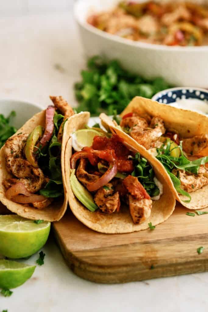 baked chicken fajitas on tortillas on a cutting board