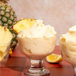 Disneyland Dole Whips in glasses garnished with slices of pineapple.