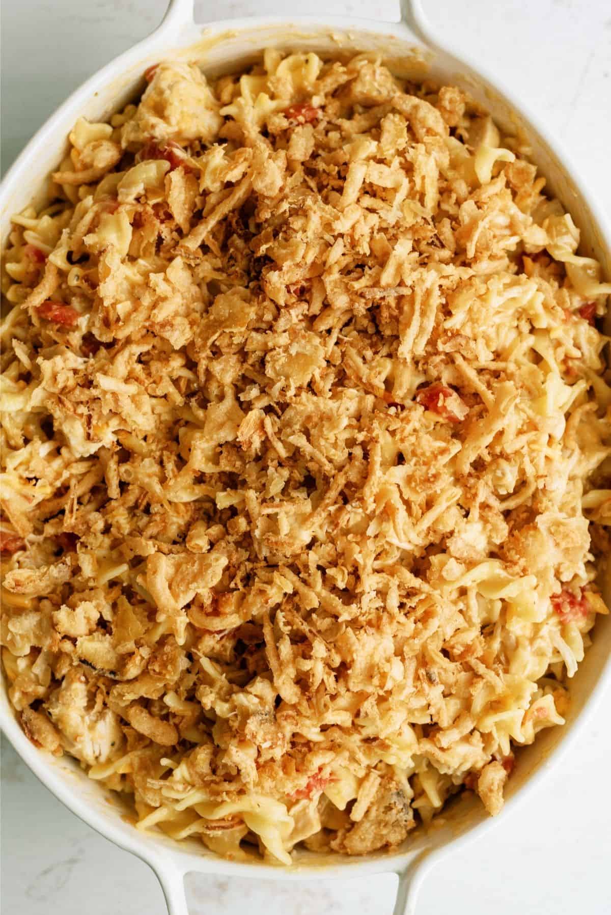 Unbaked French Onion Chicken Noodle Casserole in a white casserole dish