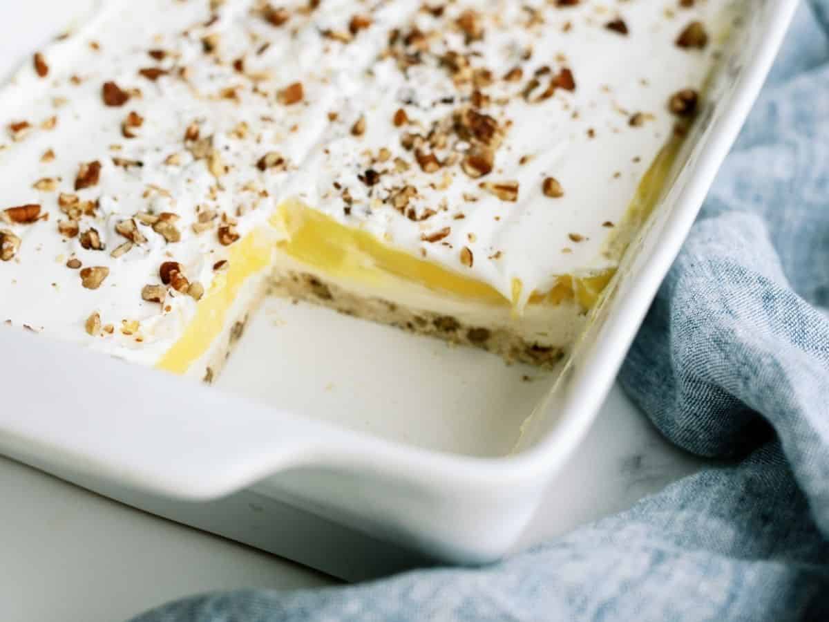 Layered Lemon Dessert in dish missing one square