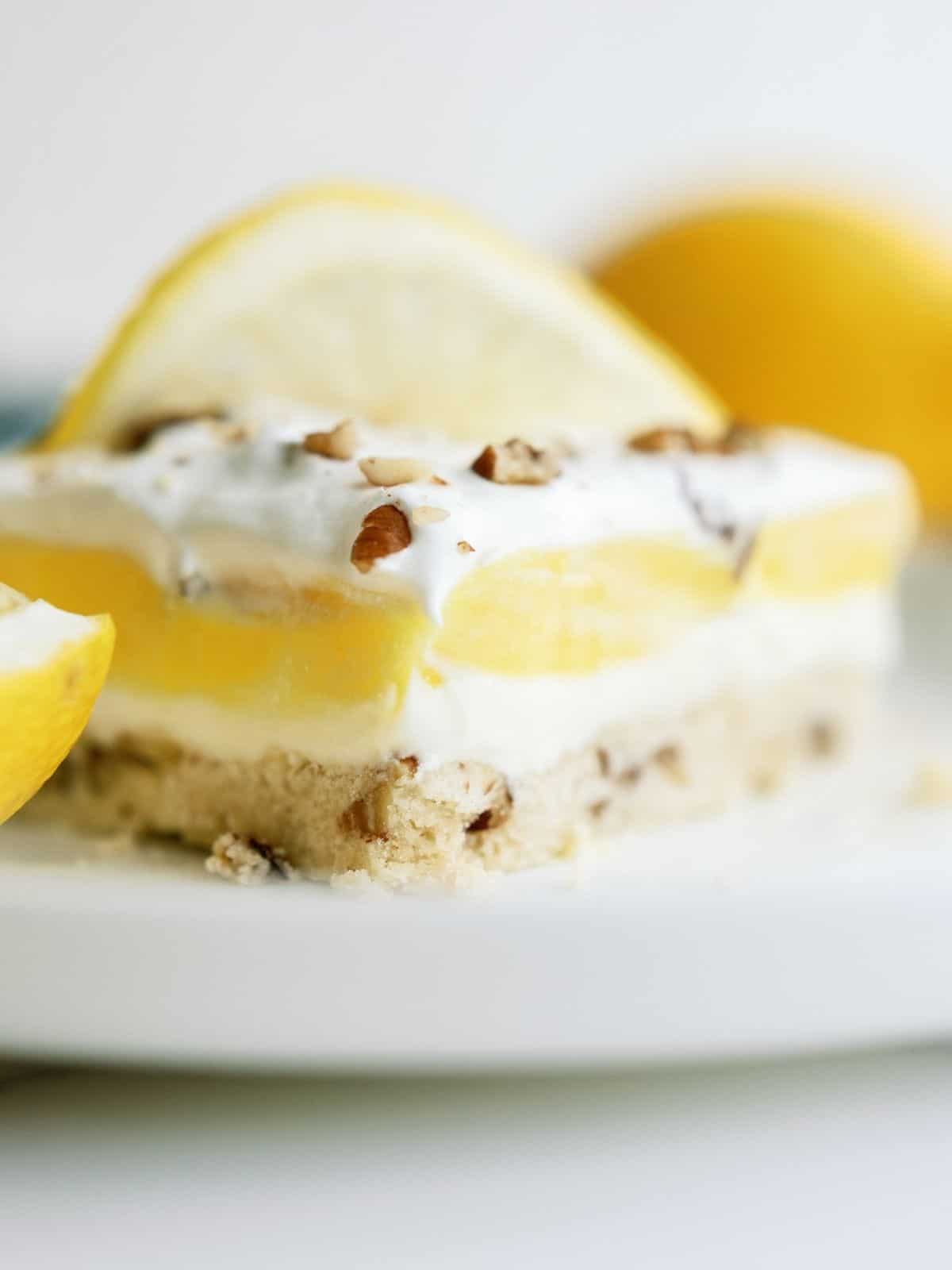 A slice of Layered Lemon Dessert on a white dish