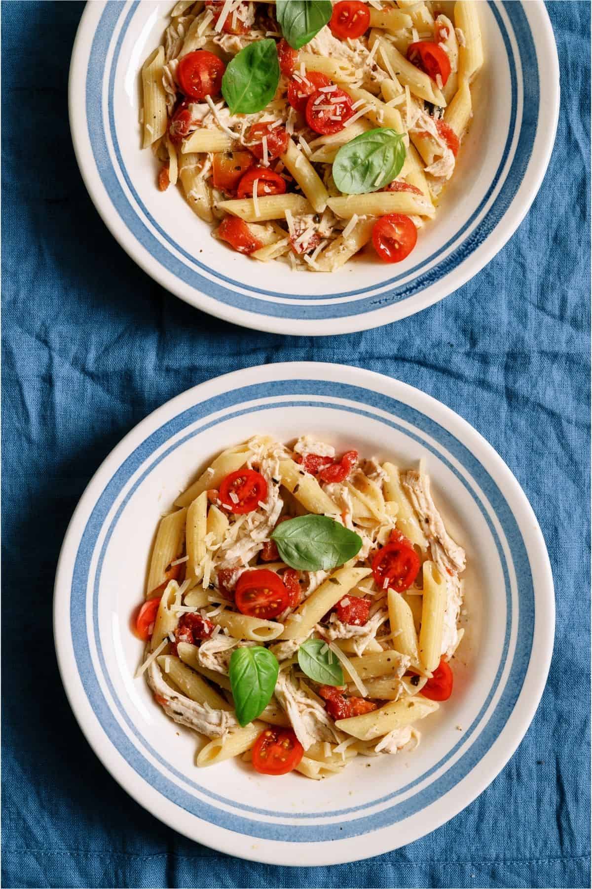 Two bowls of Slow Cooker Chicken Alfredo with Pesto.