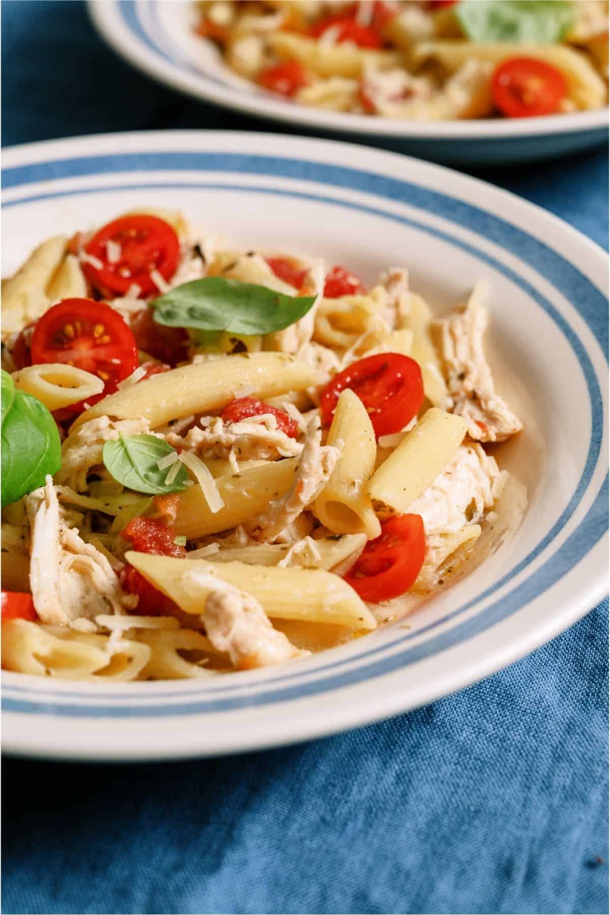 Close up of a serving of Slow Cooker Chicken Alfredo with Pesto in a bowl.