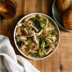 A bowl of Slow Cooker Chicken Philly Cheesesteak meat on a wooden background.