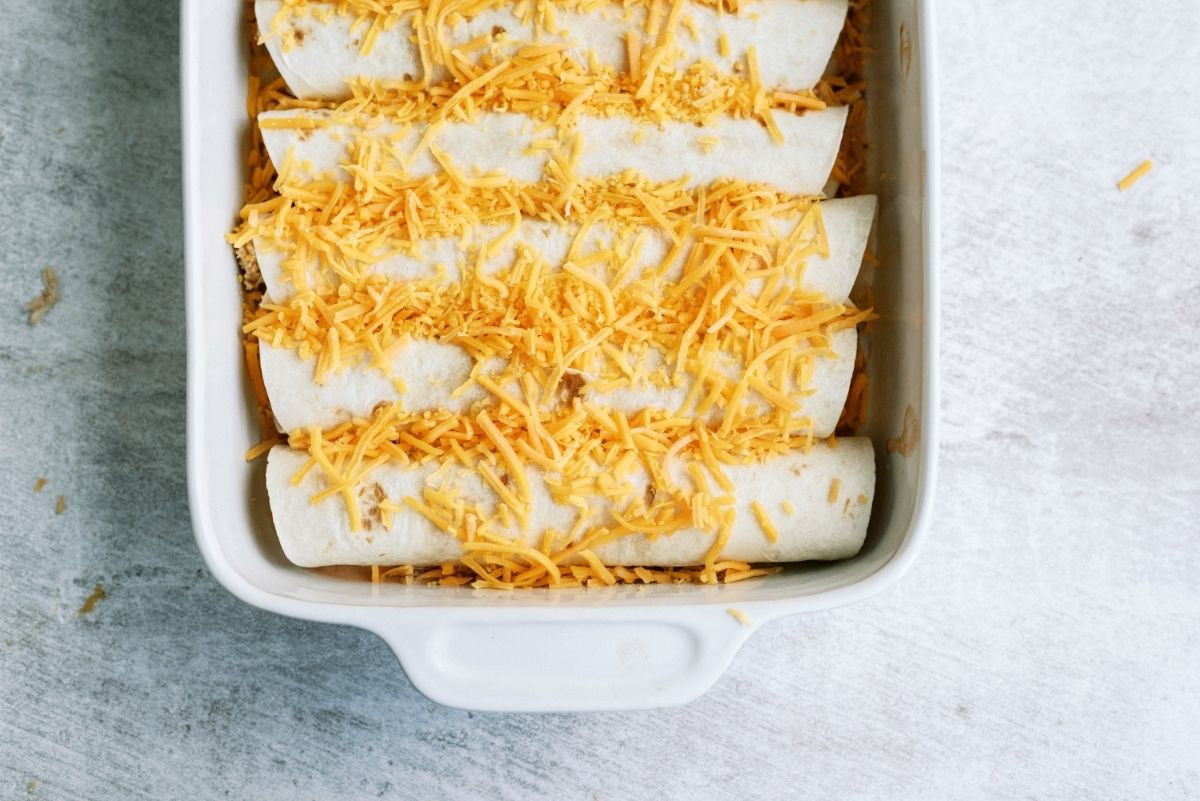 Slow Cooker Ranch Chicken Enchiladas unbaked in pan 