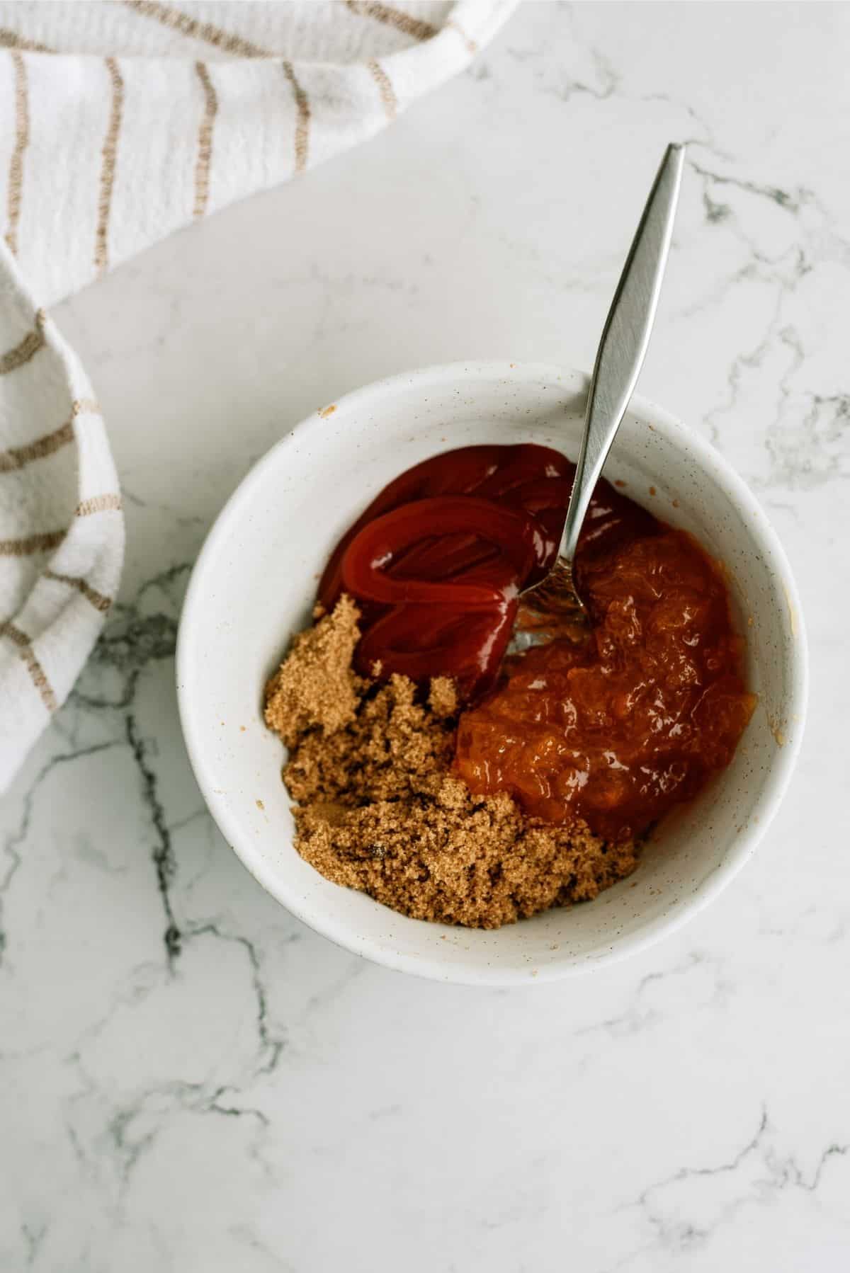 Ingredients for sauce mixed in a white bowl