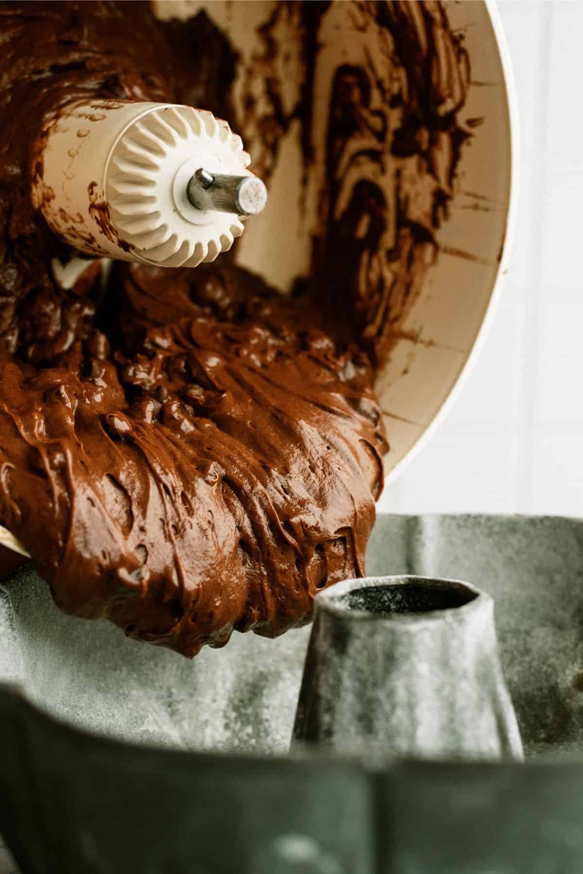 Pouring batter into prepared bundt cake pan