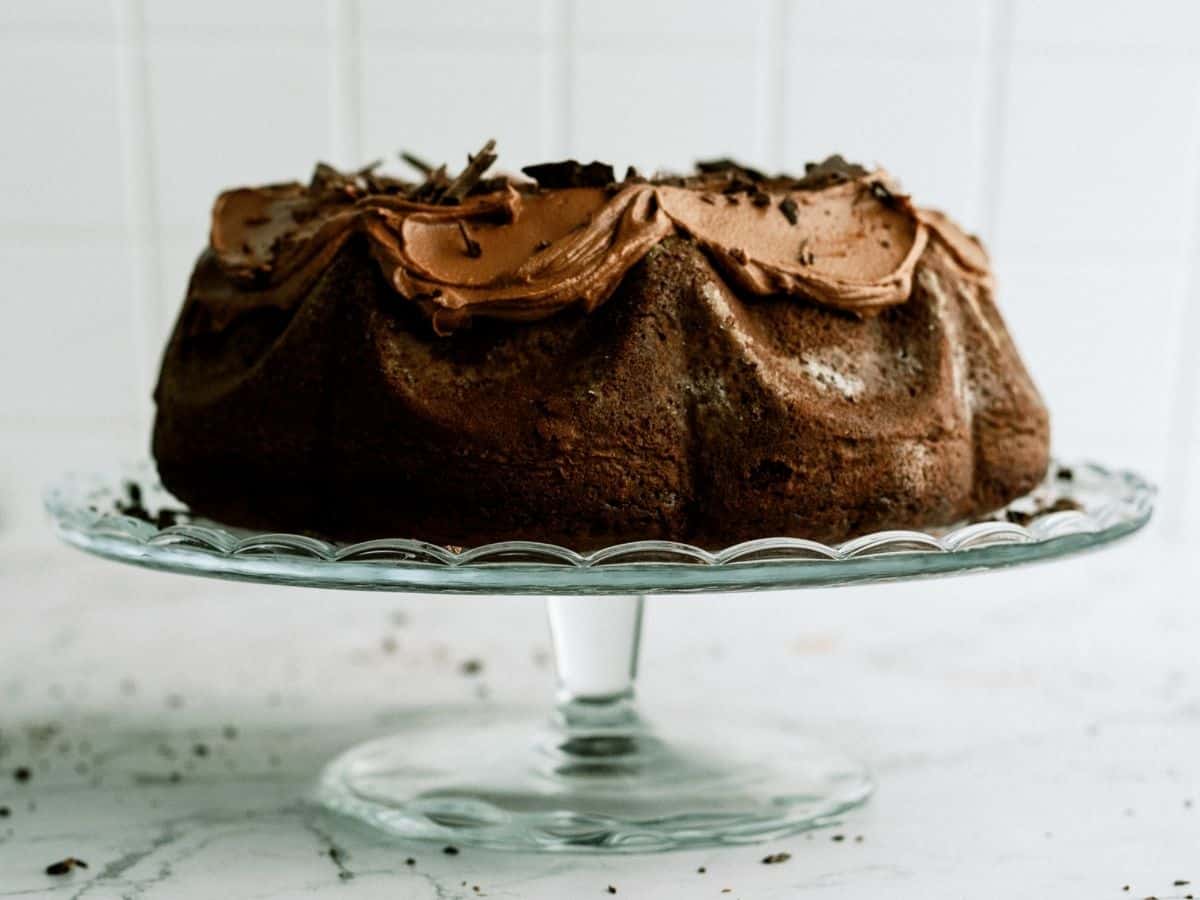 Triple Chocolate Bundt Cake on a glass cake stand