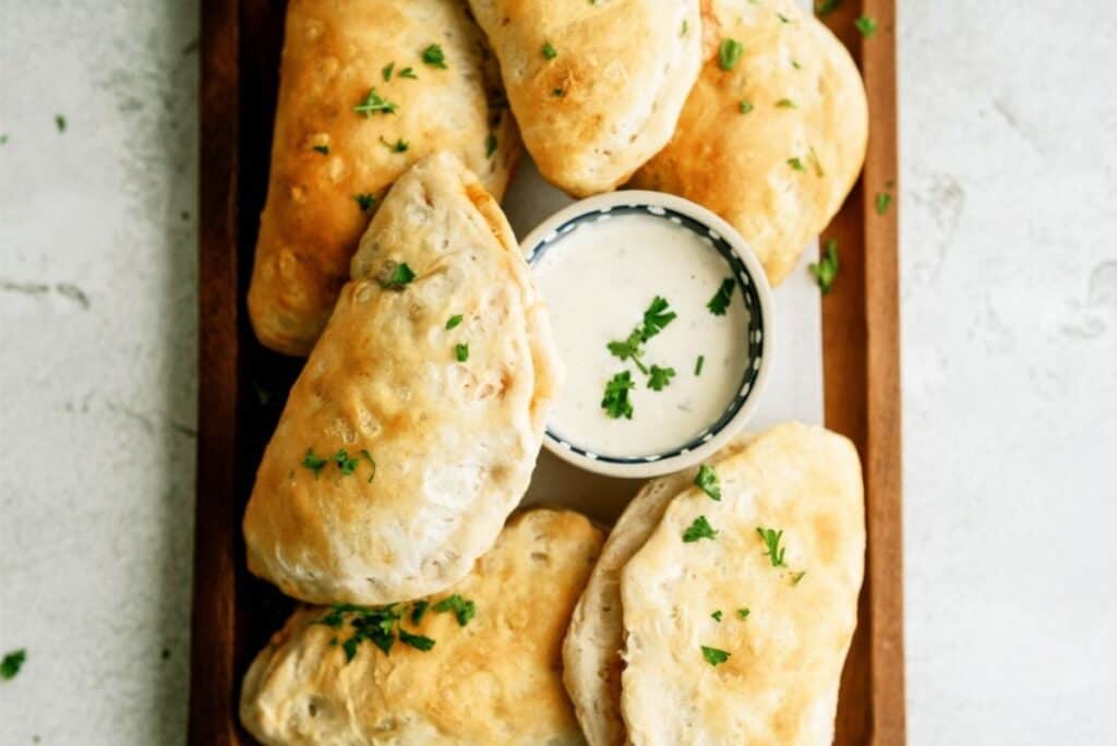 A tray of Baked Sloppy Joes with dipping sauce.
