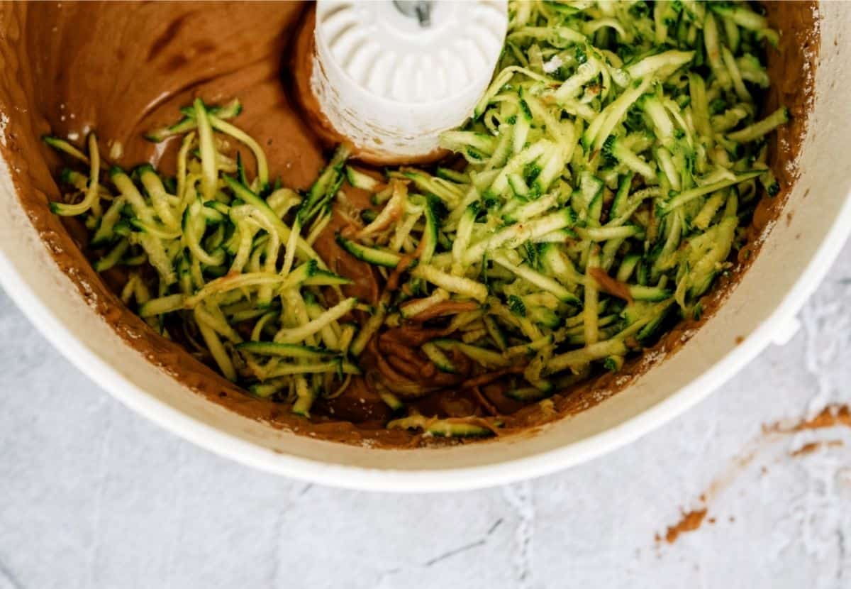 Adding shredded zucchini to cake batter