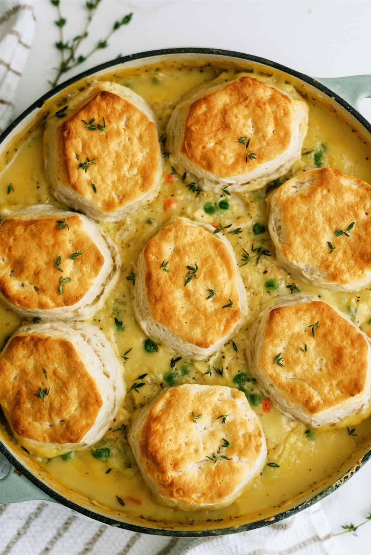 Easy Biscuit Chicken Pot Pie in a round dish on a towel