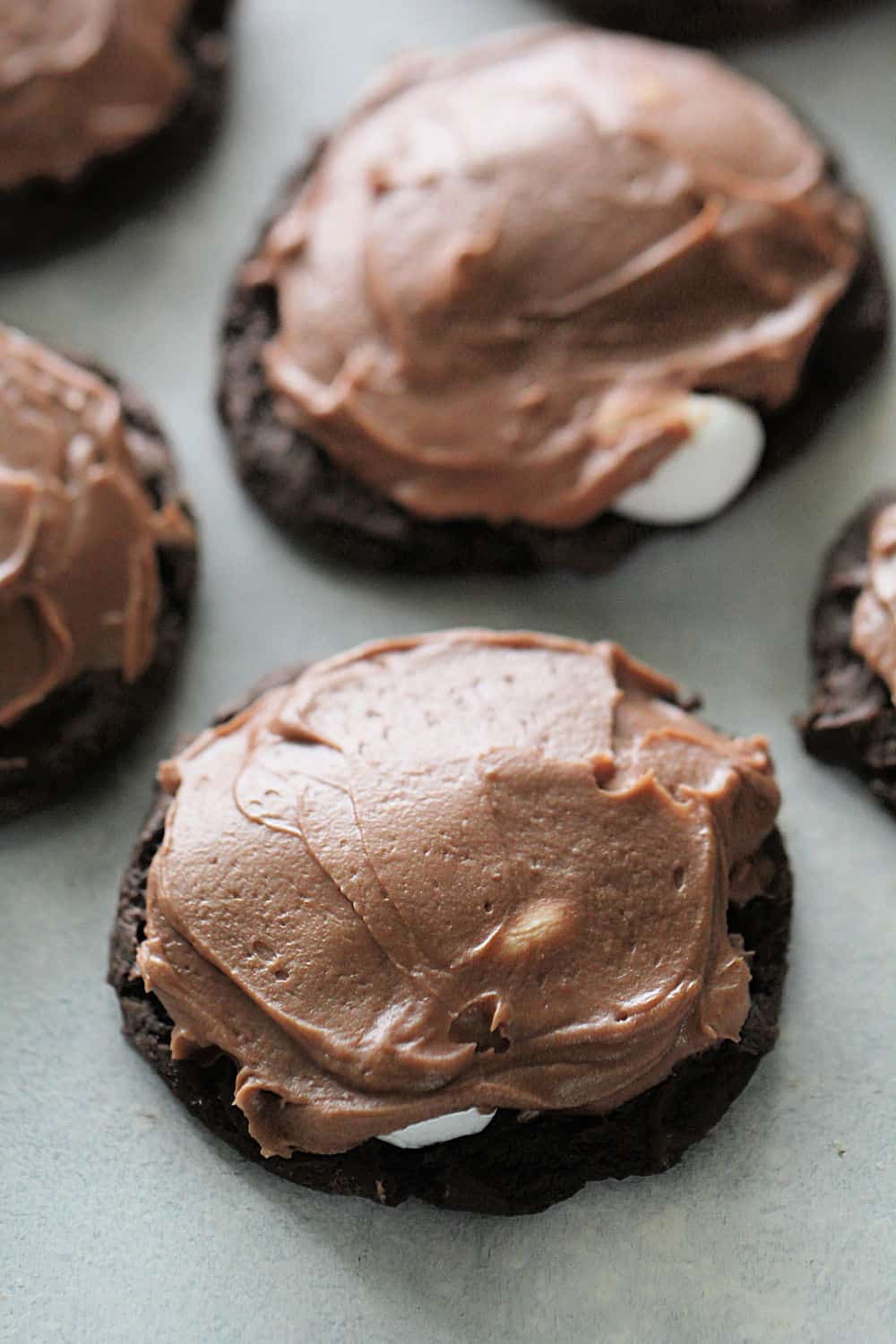 Frosted Chocolate Marshmallow Brownie Cookies on a countertop.
