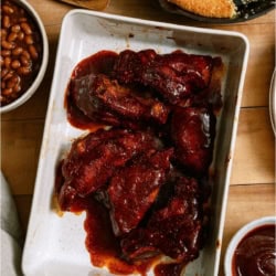 A baking dish full of Instant Pot BBQ Country Ribs in BBQ sauce.