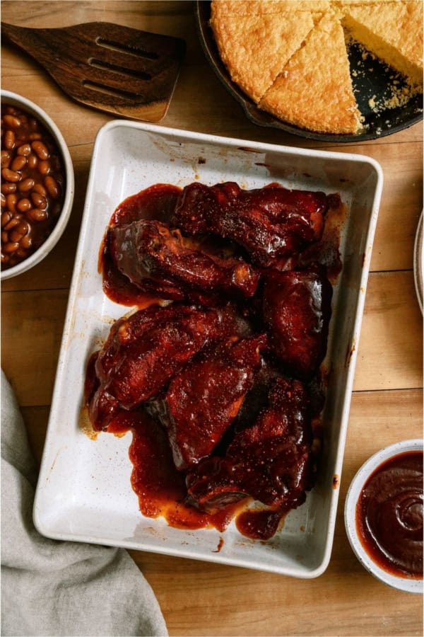 A baking dish full of Instant Pot BBQ Country Ribs in BBQ sauce.