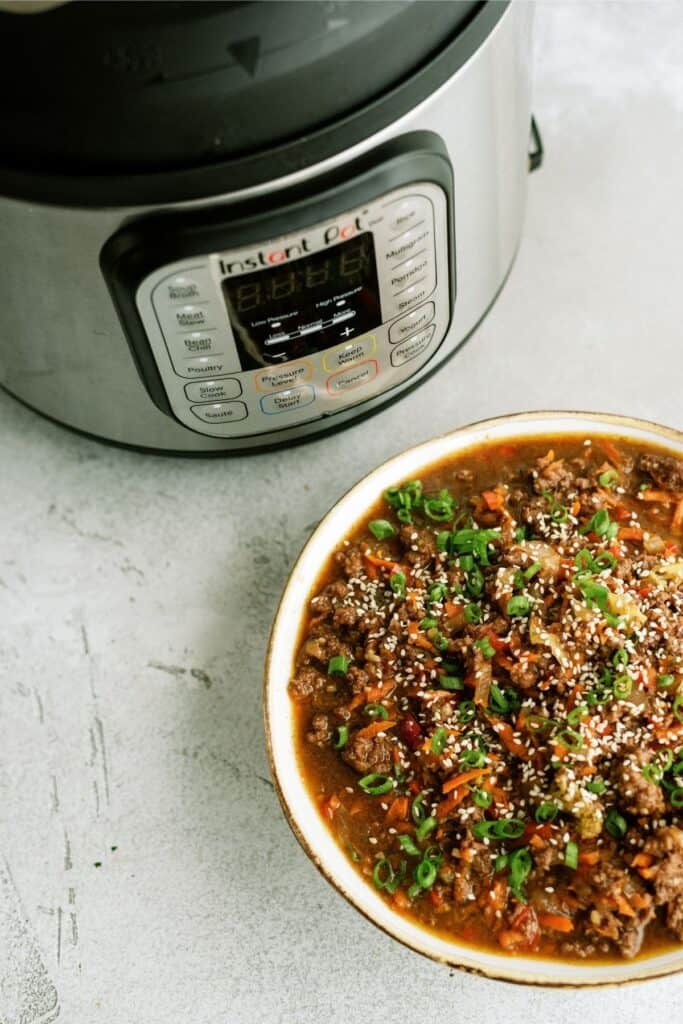 teriyaki ground turkey in a bowl next to an Instant Pot