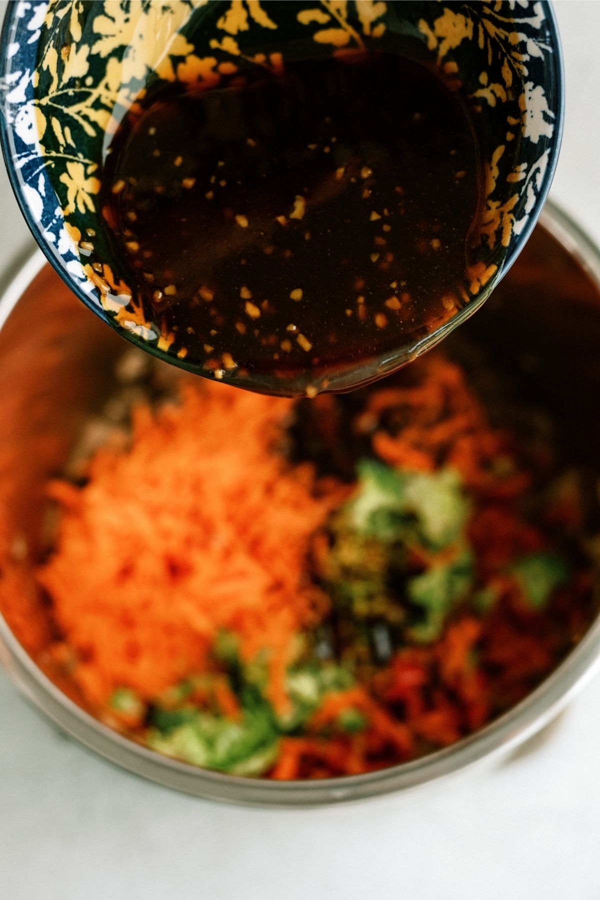 Pouring Teriyaki Sauce onto veggies in Instant Pot