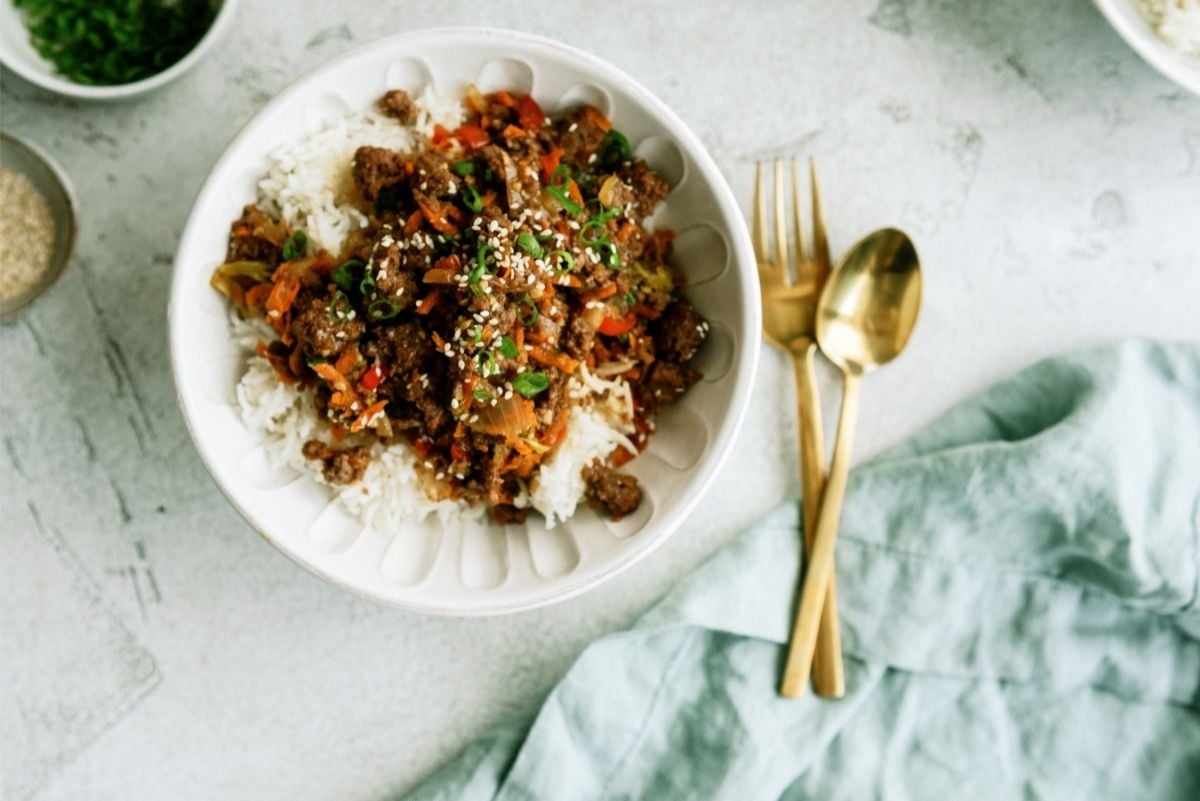 Instant Pot Ground Turkey Teriyaki Rice Bowl served in a white bowl with flatware.