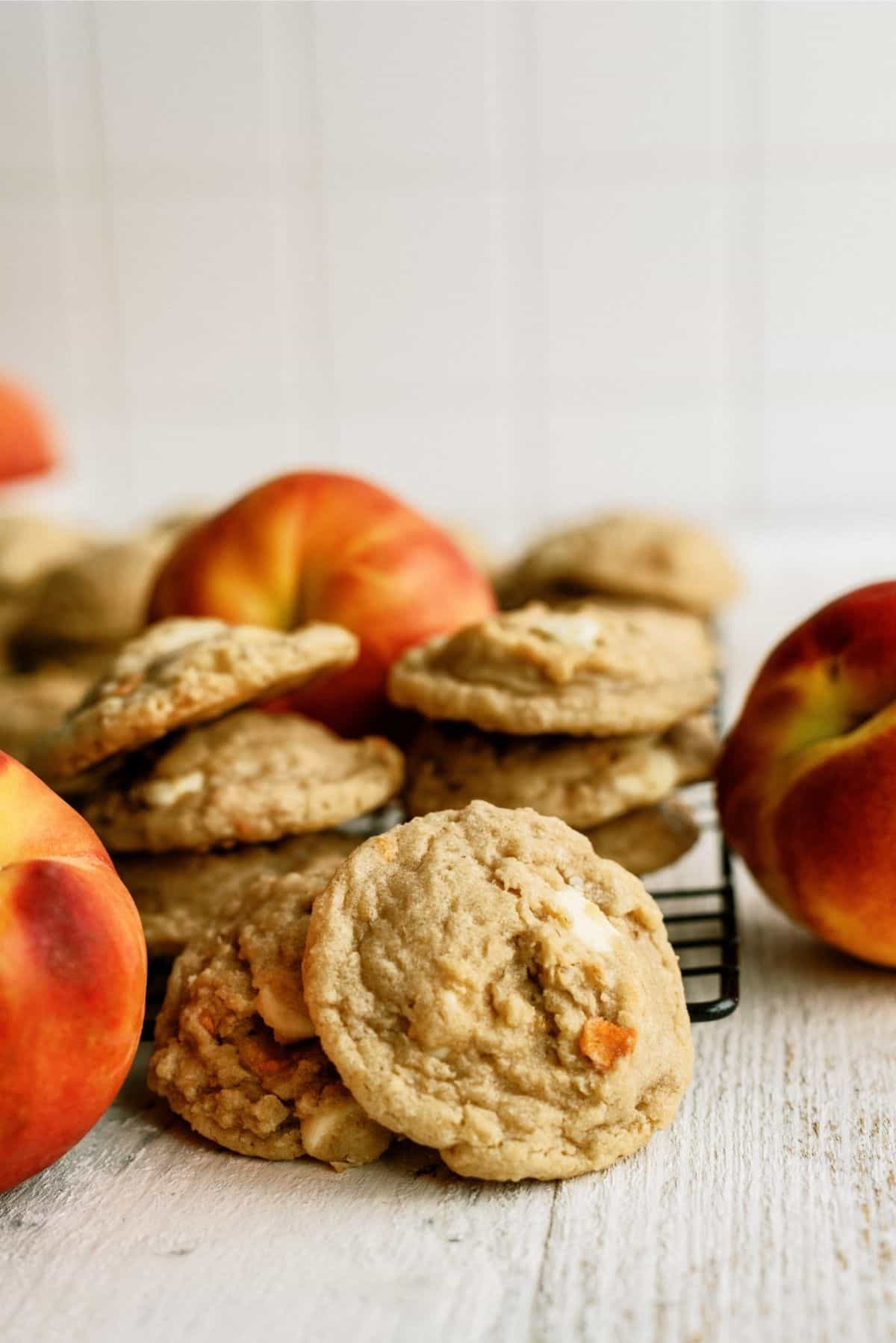 Peaches and Cream Oatmeal Cookies on cooling rack surrounded by fresh pizza