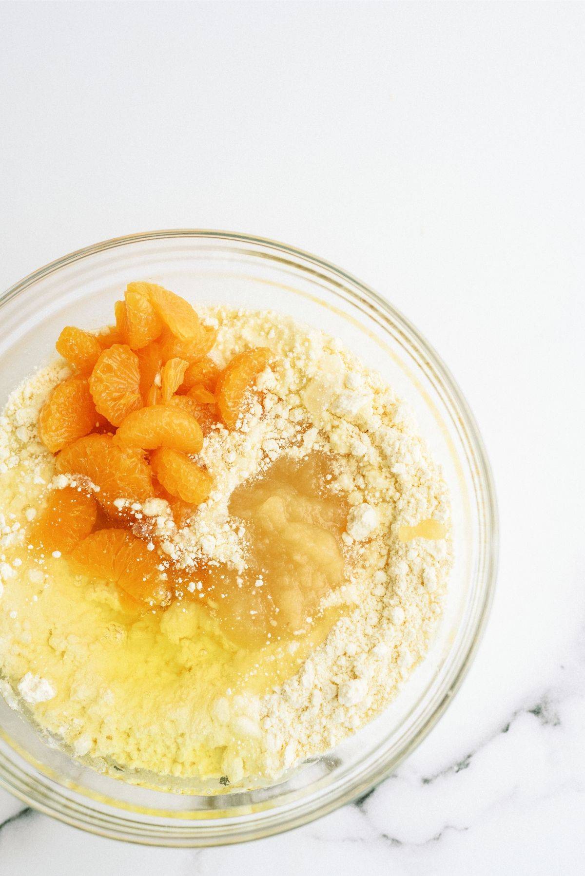 Cake Mix, Mandarin Oranges, Egg whites and applesauce in a glass bowl