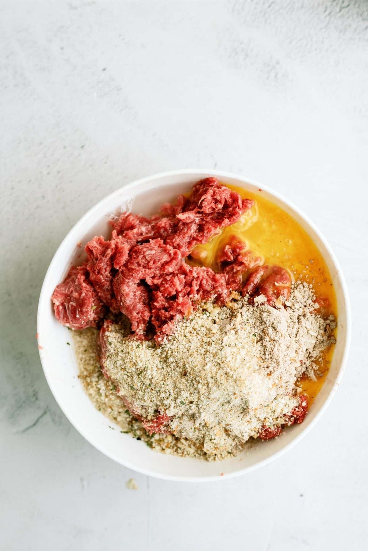 ground beef, Italian bread crumbs, french onion soup mix, beaten egg, and water mixed together in a large bowl