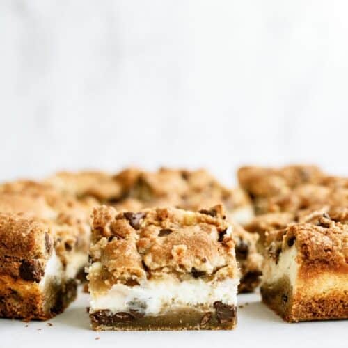 Chocolate Chip Cheesecake Blondies sliced into squares to show the inside.