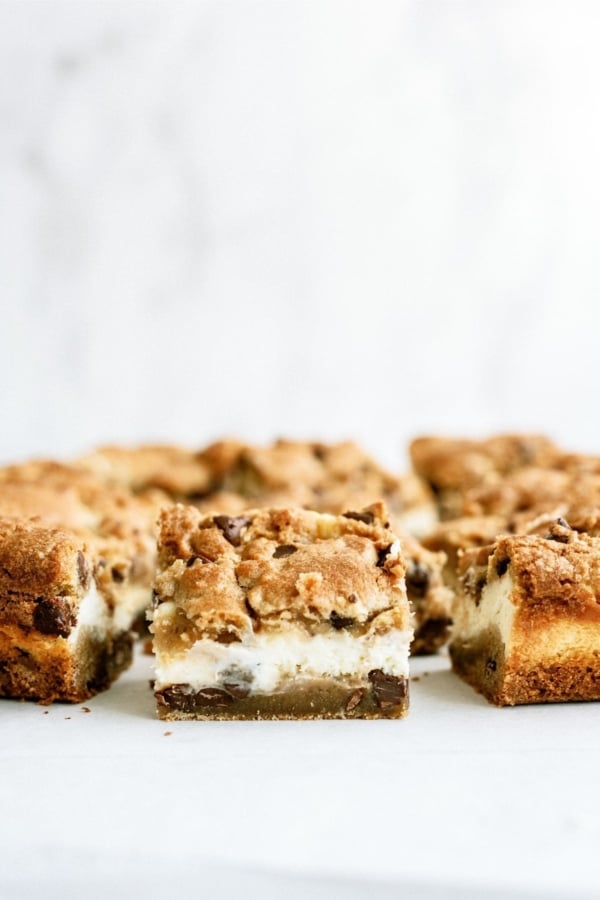 Chocolate Chip Cheesecake Blondies sliced into squares to show the inside.