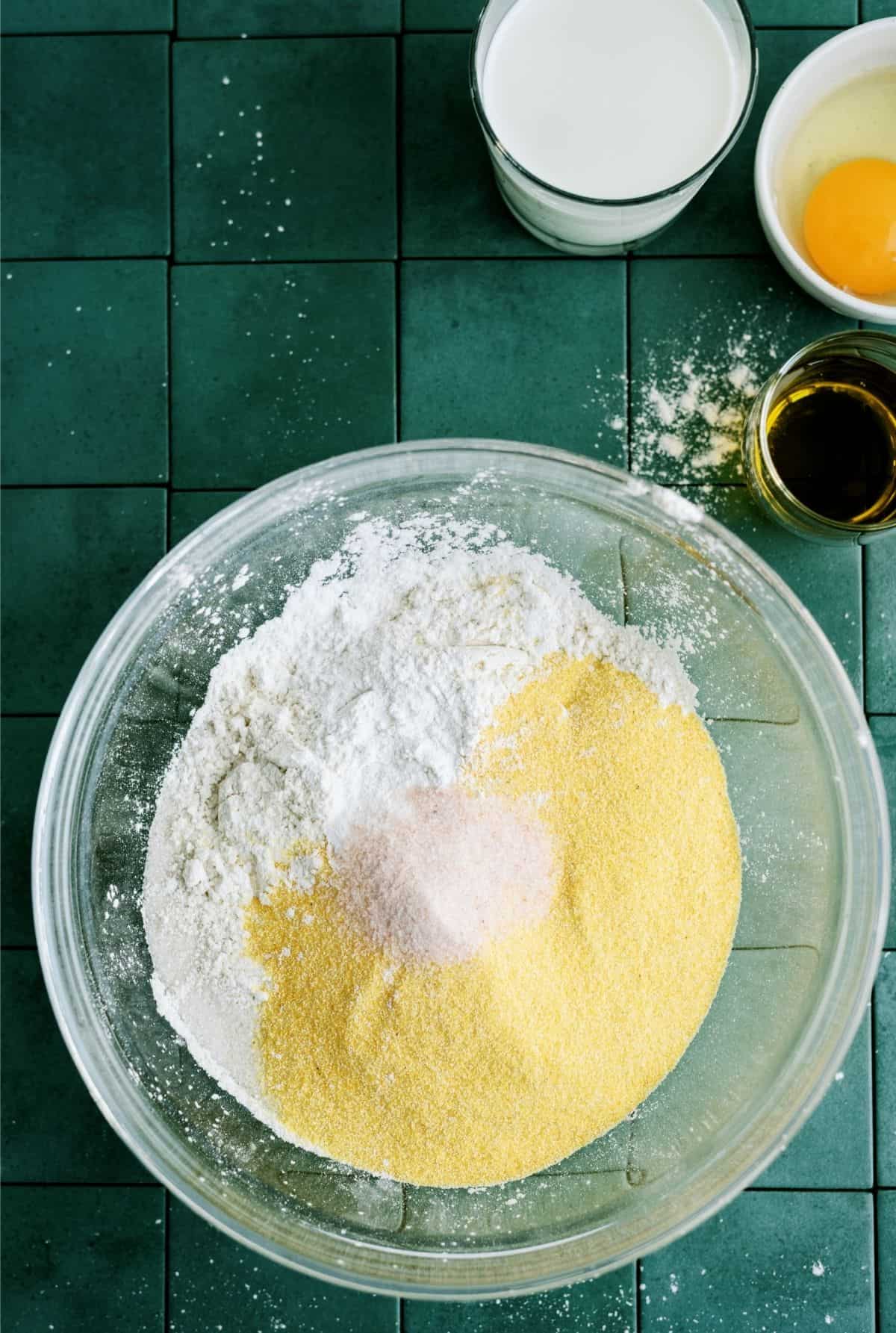 Dry ingredients for Easy Homemade Cornbread mixed in a glass bowl