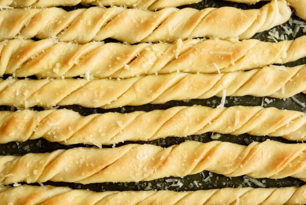 Freshly baked Homemade Pizza Factory Breadsticks on a sheet pan.