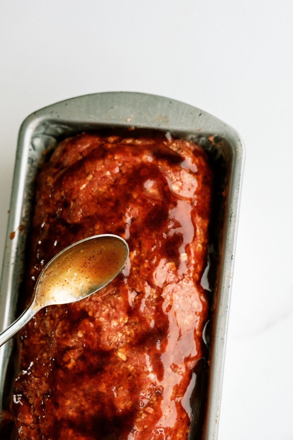 Spreading BBQ Sauce over unbaked Meatloaf