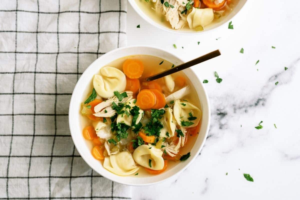 Instant Pot Chicken Tortellini and Vegetable Soup in a white bowl