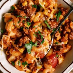 A bowl of Instant Pot Ground Beef Goulash with a spoon.