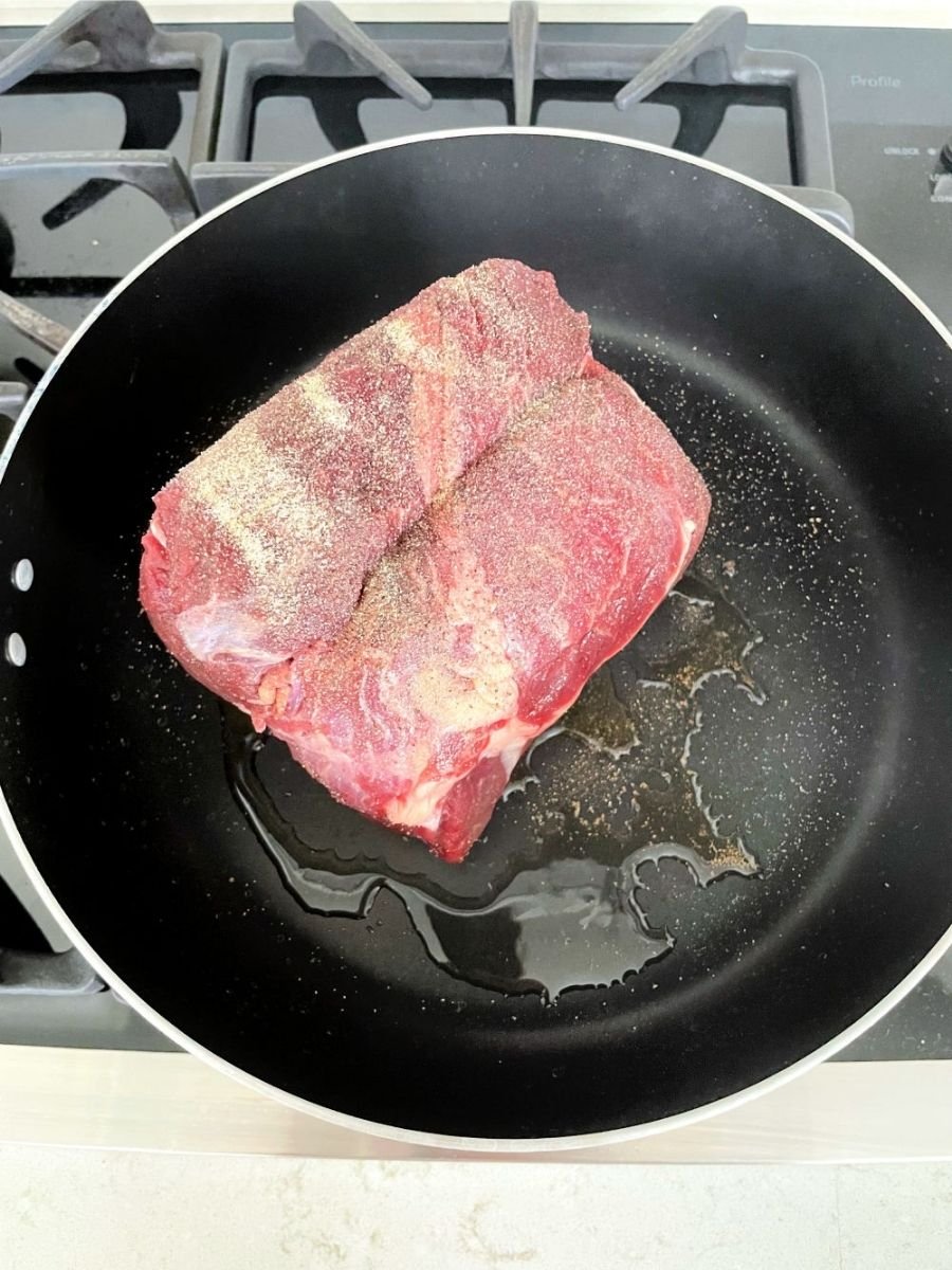 sear roast on stove top with oil and seasonings