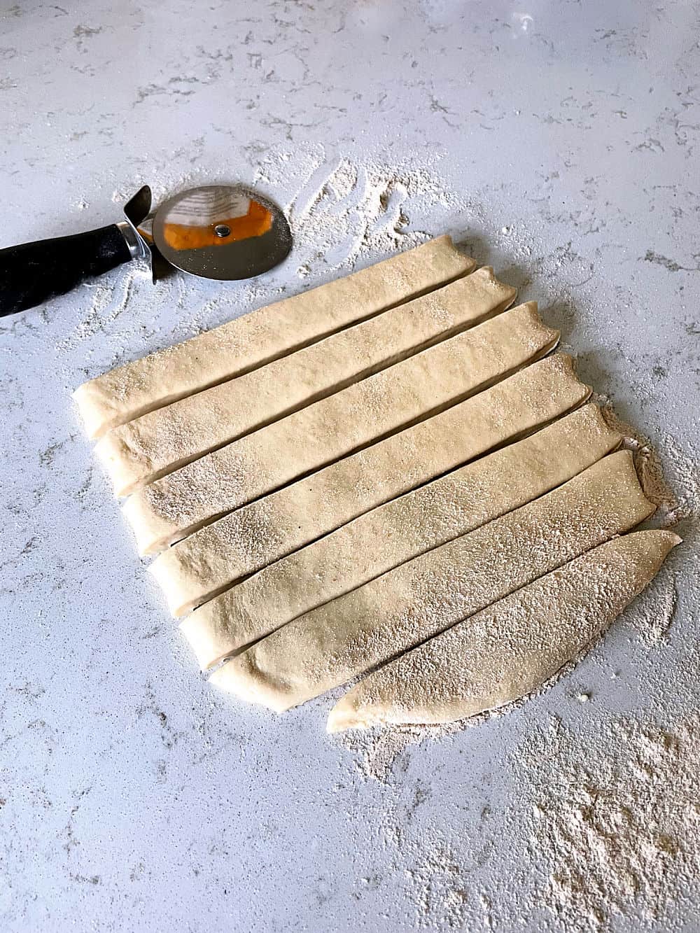 bread dough cut into strips for breadsticks