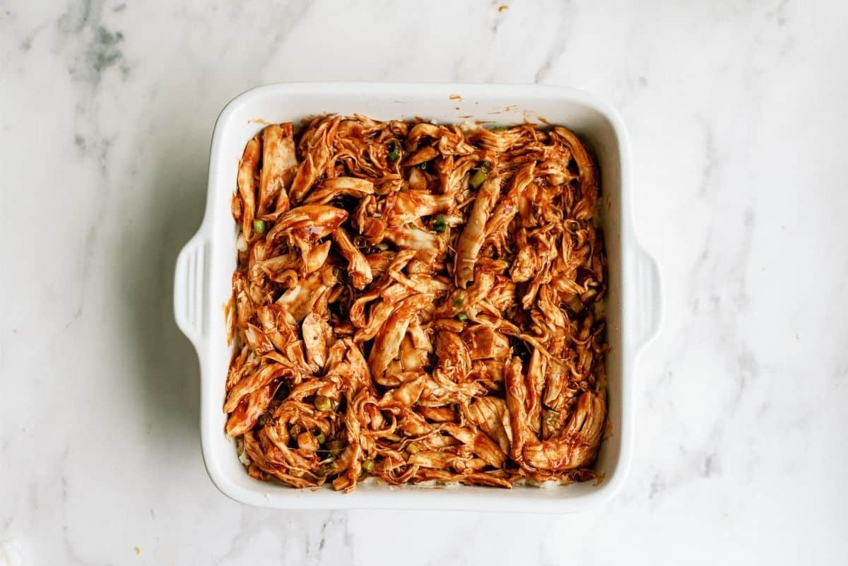 Chicken mixture on top on potato mixture in casserole dish