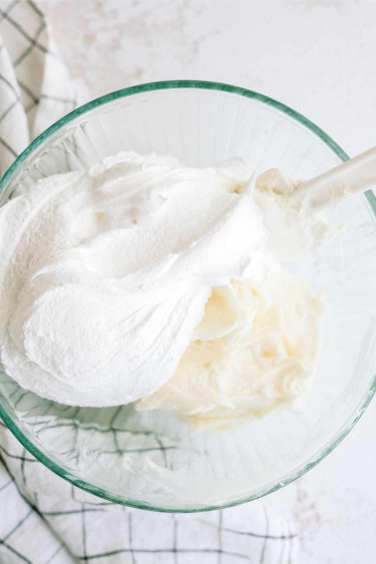 Cool Whip, Cream cheese and powdered sugar in a glass mixing bowl