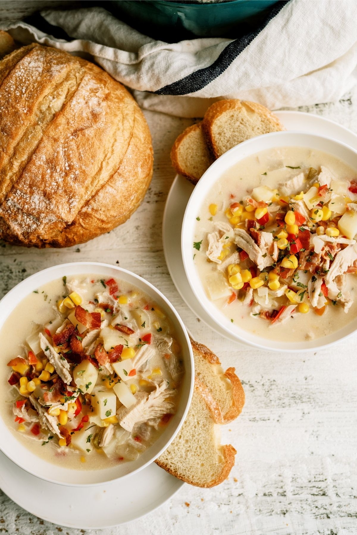 Chicken Corn Chowder in two bowls served with sliced bread